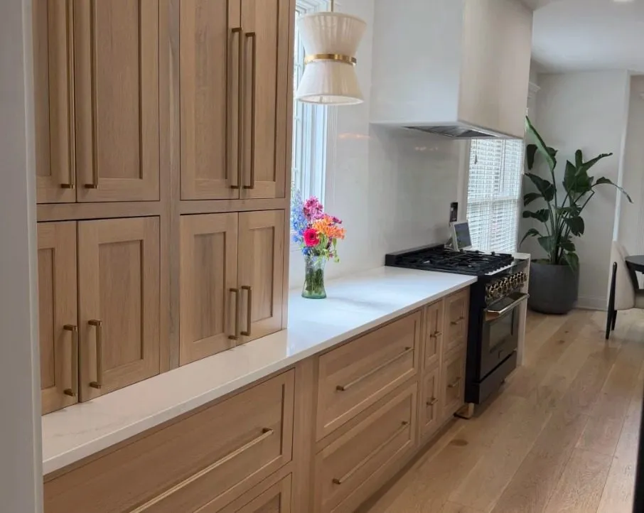 White oak cabinetry wall with brass pulls